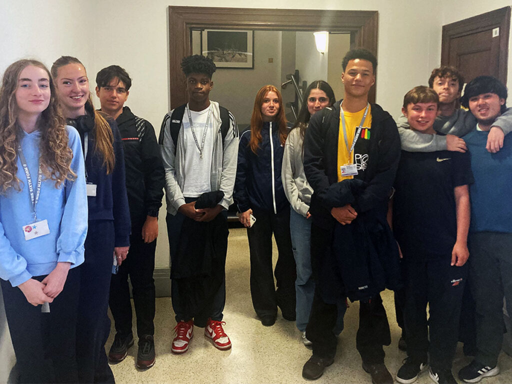 A group of East Barnet School students in a Royal Geographical Society corridor.